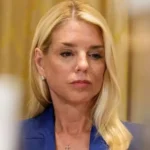 US Attorney General Pam Bondi, dressed in a blue suit, looks down during a hearing.